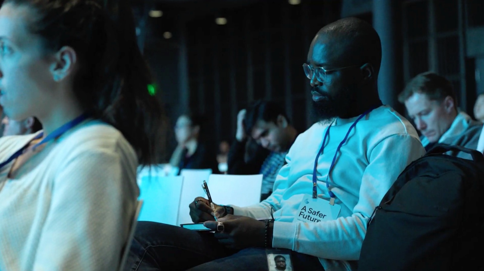 Attendee taking notes during a summit session