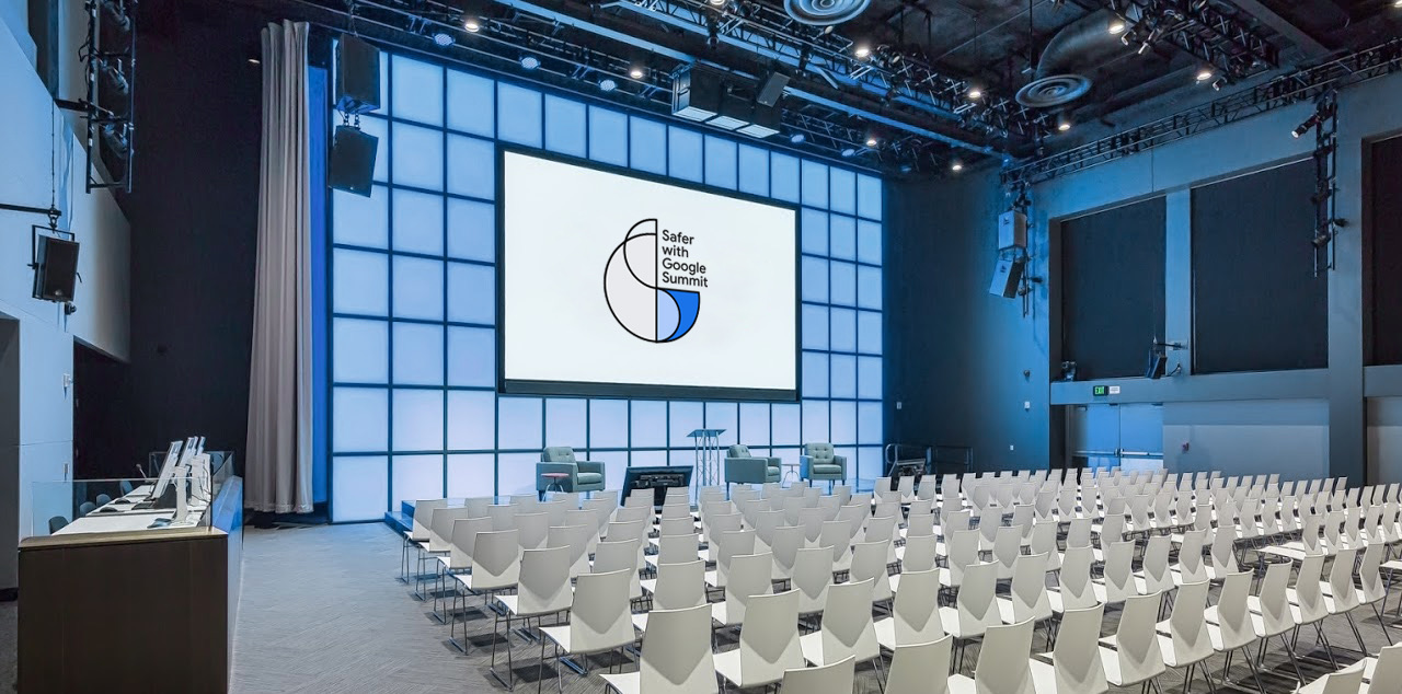 Empty summit auditorium with the Safer with Google Summit logo on the main stage screen
